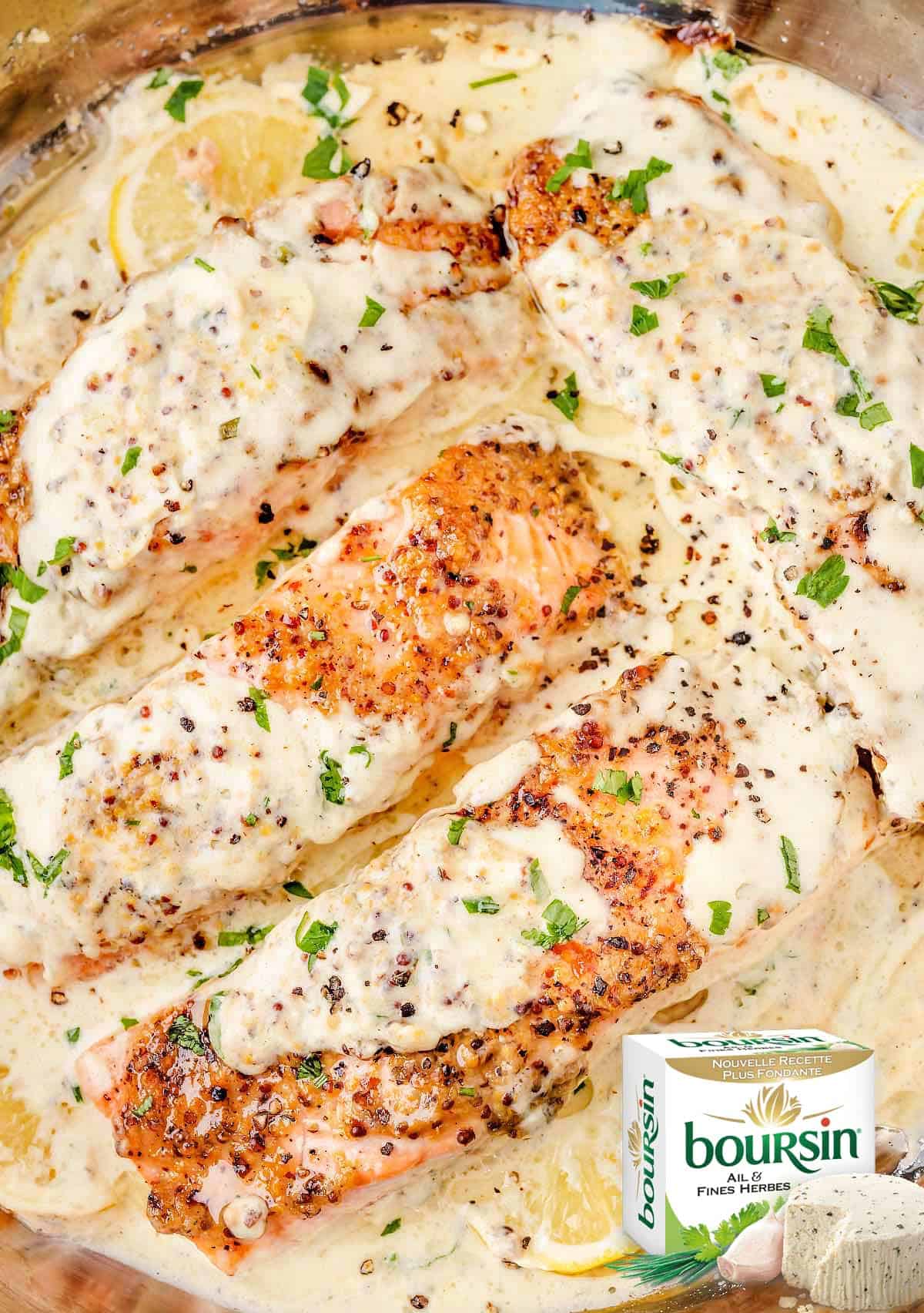 Overhead view of succulent Boursin salmon fillets in a creamy skillet sauce.