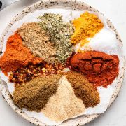 Assorted spices on a plate, ready to be mixed for Homemade Southwest Seasoning.