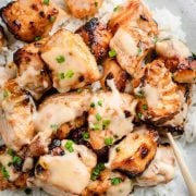 Crispy Air Fryer Cajun Bang Bang Salmon Bites served over steamed rice in a white bowl.