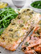 Close-up of a Baked Dijon Salmon fillet, showcasing its Dijon mustard and mayo topping and savory appearance.