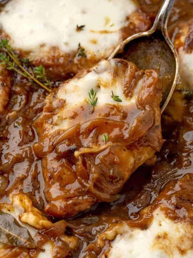 Close-up view of a French Onion Chicken fillet, showcasing the golden-brown crust, topped with rich, caramelized onions and melted cheese.