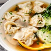 Image of Wonton Soup in a white bowl, showing delicate wontons submerged in a savory broth.