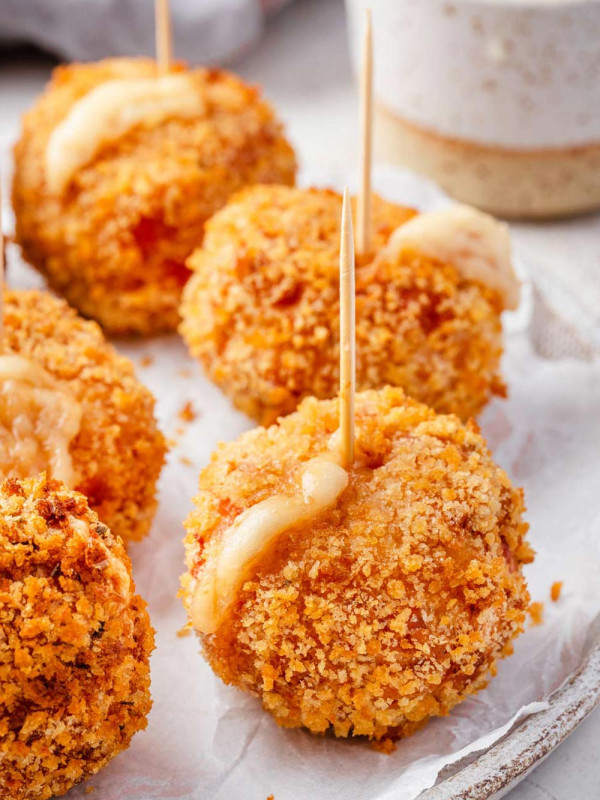 Chicken Cordon Bleu Bites served as appetizers on a plate with toothpicks.
