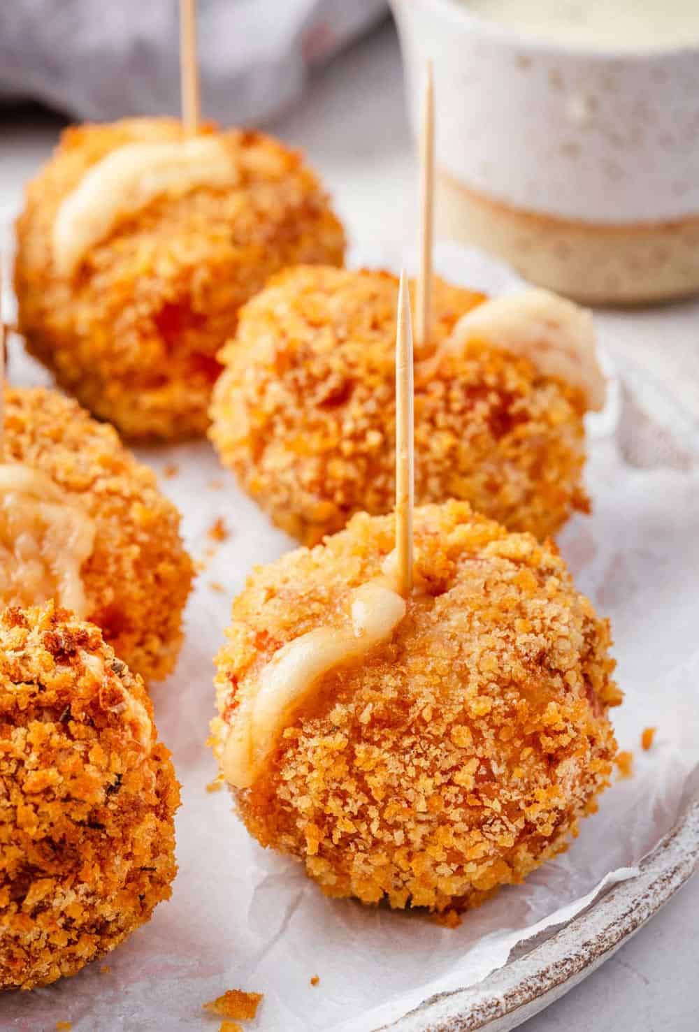 Chicken Cordon Bleu Bites served as appetizers on a plate with toothpicks.