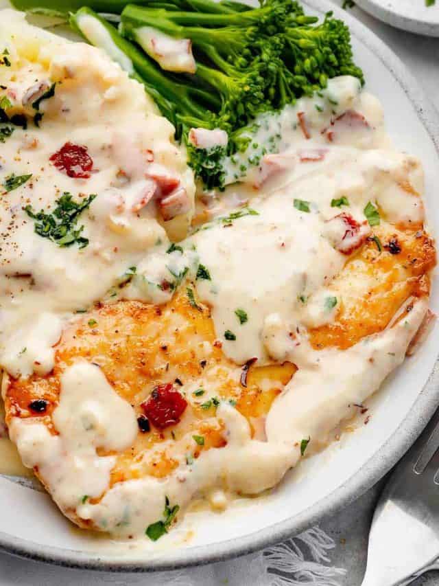 Delicious creamy ranch chicken fillet served atop creamy mashed potatoes with a side of vibrant broccolini.