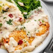 Delicious creamy ranch chicken fillet served atop creamy mashed potatoes with a side of vibrant broccolini.