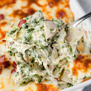 A spoonful of creamy Spinach Artichoke Chicken Casserole.