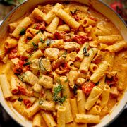 The overhead image of Tuscan chicken pasta in a white skillet.