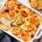 Overhead view of baked crab dip with shrimp and crackers.