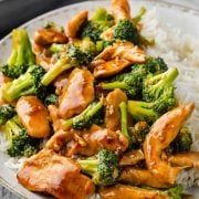 A bowl of chicken and broccoli served over rice.