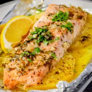 Baked Pineapple Salmon Foil Packet on a plate with pineapple slices.