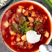 Overhead view of a plate filled with borscht soup.