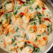 A skillet filled with creamy Tuscan butter shrimp.