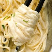 Creamy fettuccine Alfredo coated in rich, velvety sauce and garnished with fresh parsley.