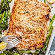 Sheet pan salmon with broccolini, roasted and served with lemon wedges.