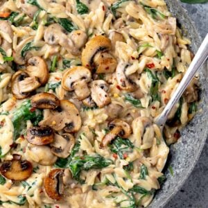 Creamy spinach and mushroom orzo with sautéed mushrooms, fresh spinach, and Parmesan in a rich garlic cream sauce.