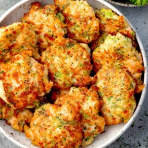 Crispy broccoli chicken fritters with melted mozzarella cheese, golden brown and served in a bowl, easy homemade chicken fritter recipe.