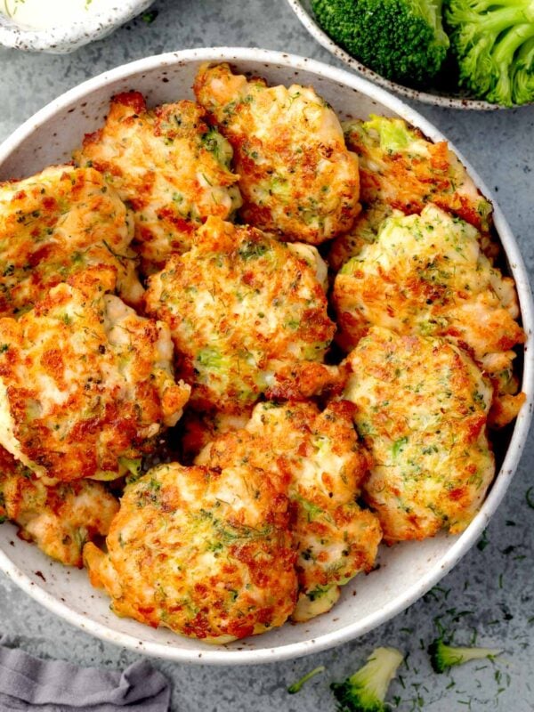 Crispy broccoli chicken fritters with melted mozzarella cheese, golden brown and served in a bowl, easy homemade chicken fritter recipe.