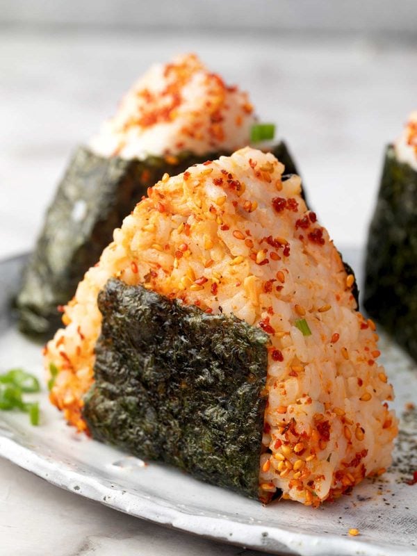 Salmon onigiri rice balls with spicy salmon, furikake, and crisp nori seaweed.