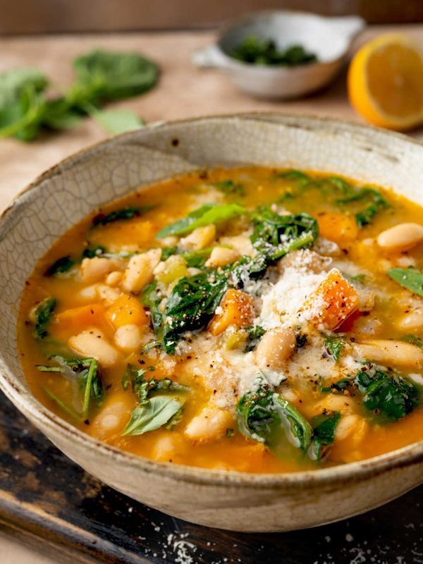 Italian spinach soup with white beans, carrots, Parmesan, and fresh spinach in a savory broth.