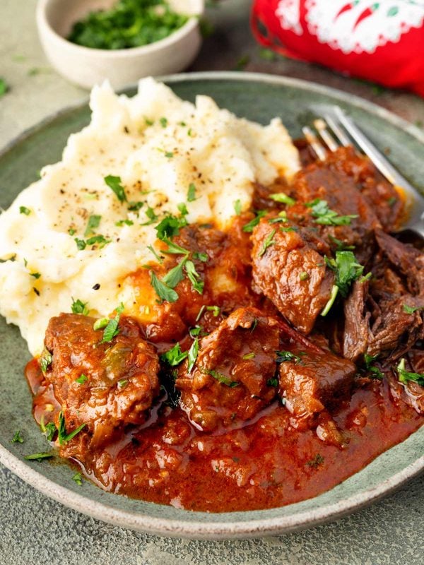 Hungarian goulash with tender beef in rich paprika sauce served with creamy mashed potatoes.