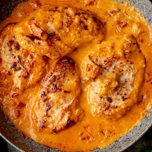 Creamy Paprika Chicken with golden-seared chicken breasts simmered in a rich, silky paprika cream sauce with garlic and sun-dried tomatoes in a skillet.